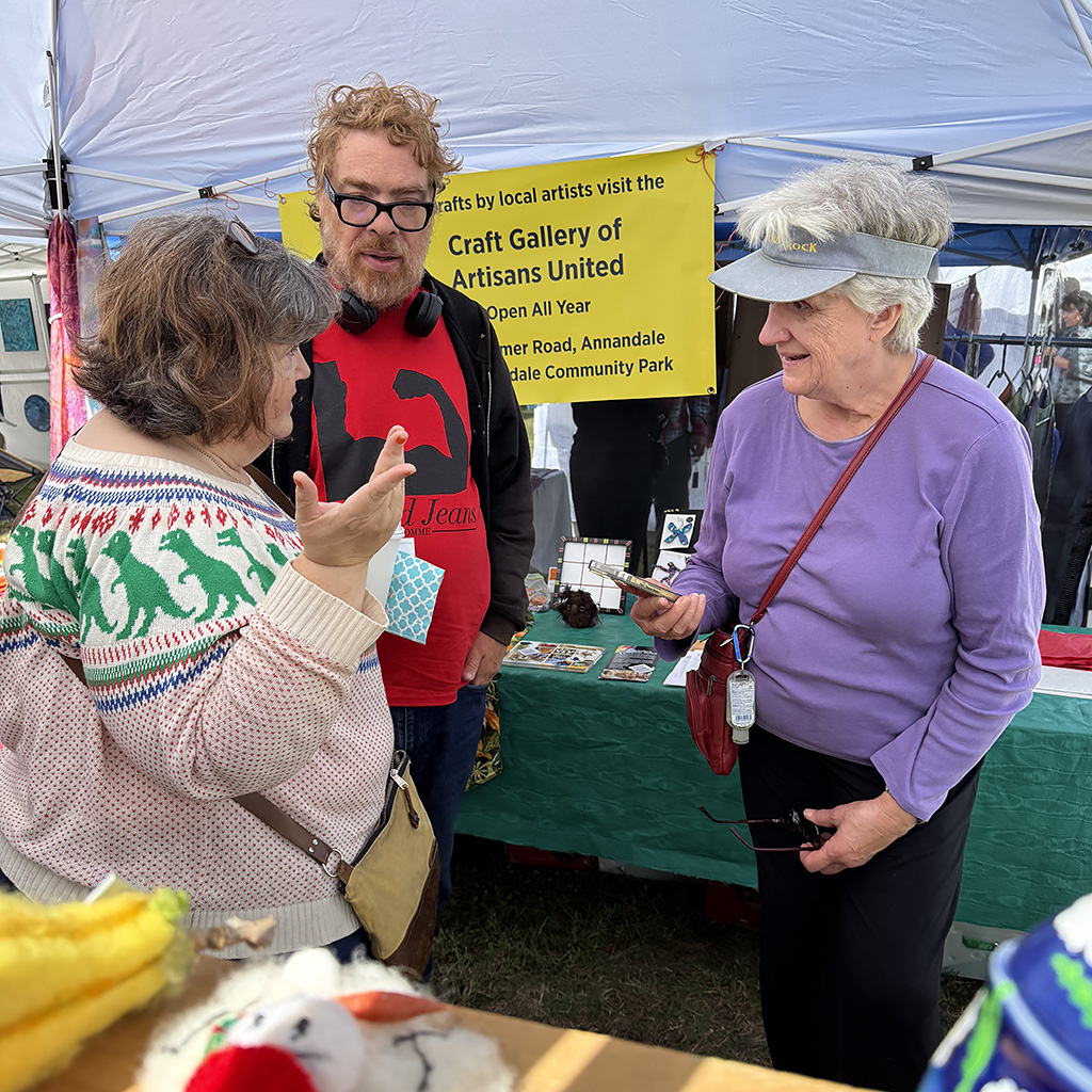 Claire Gesalman(right), from Artisans United in Annandale chats with visitors to the Artisans United booth.