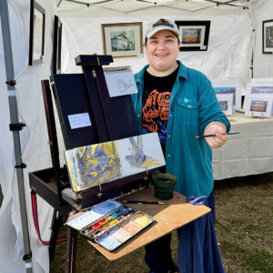 Artist Mairi Thorne encourages visitors at her booth to experiment with watercolors.