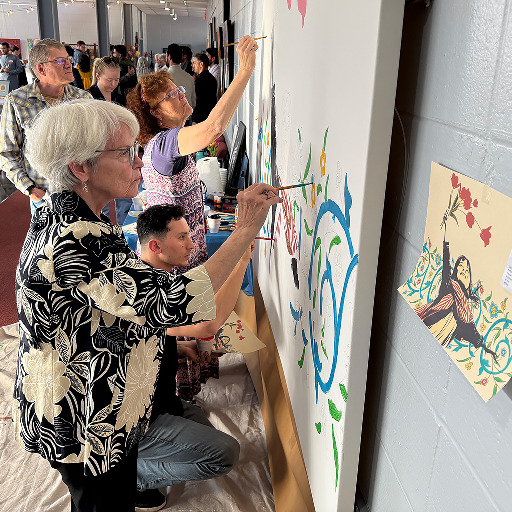 Attendees working on a group mural project during the Nowruz celebration on March 21, 2026 at John Calvin Presbyterian Church in Annandale, VA.