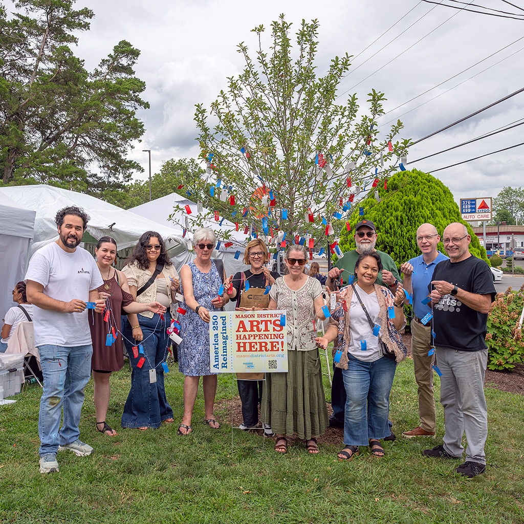 Volunteers from the Mason District Arts Council community mural project and Wishing Tree pose after hanging the last of the wish tags gathered from mid-May to late June 2026.