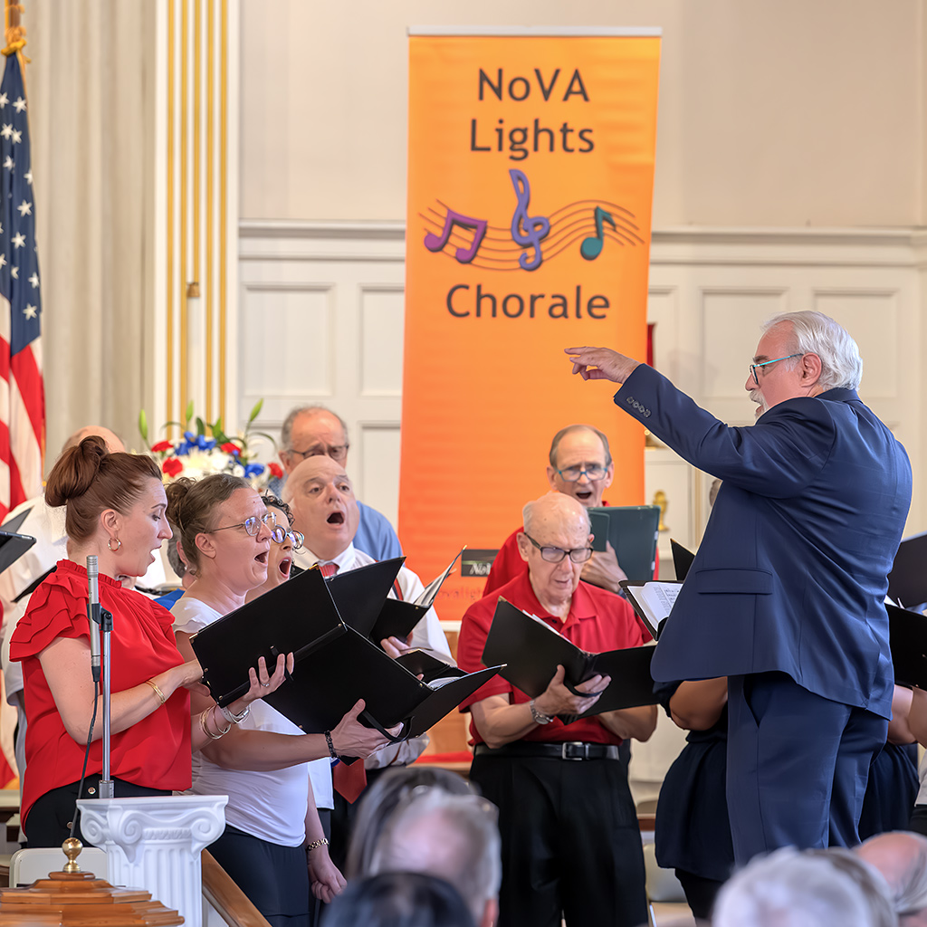 NoVA Lights Chorale artistic director Stanley Livengood leads the singers during the patriotic celebration.