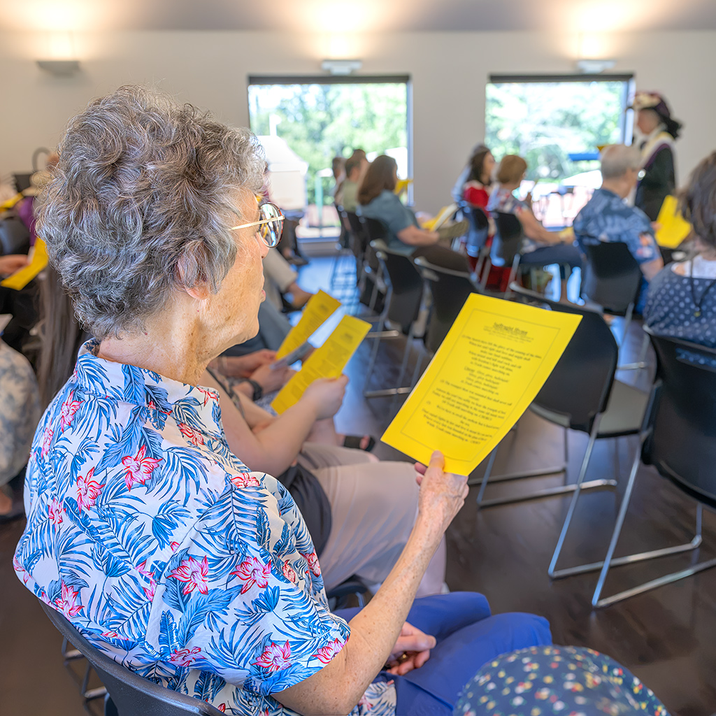 Audience member Cathy Becker sings the “Suffragist Hymn” during the performance of “Suffragist Mrs. Robert Walker.”