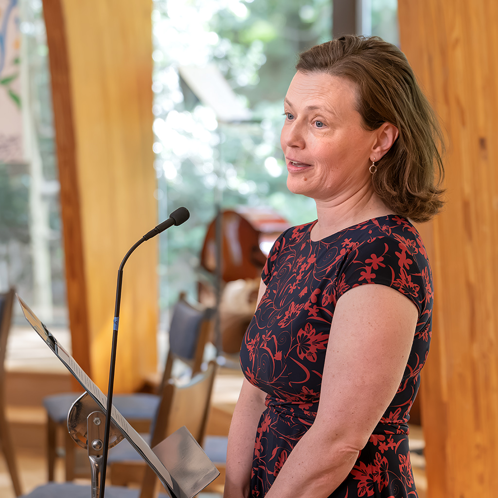 Mason District Arts Council poetry contest organizer Lisa Lowry reads the Emma Lazarus poem "The New Colossus."