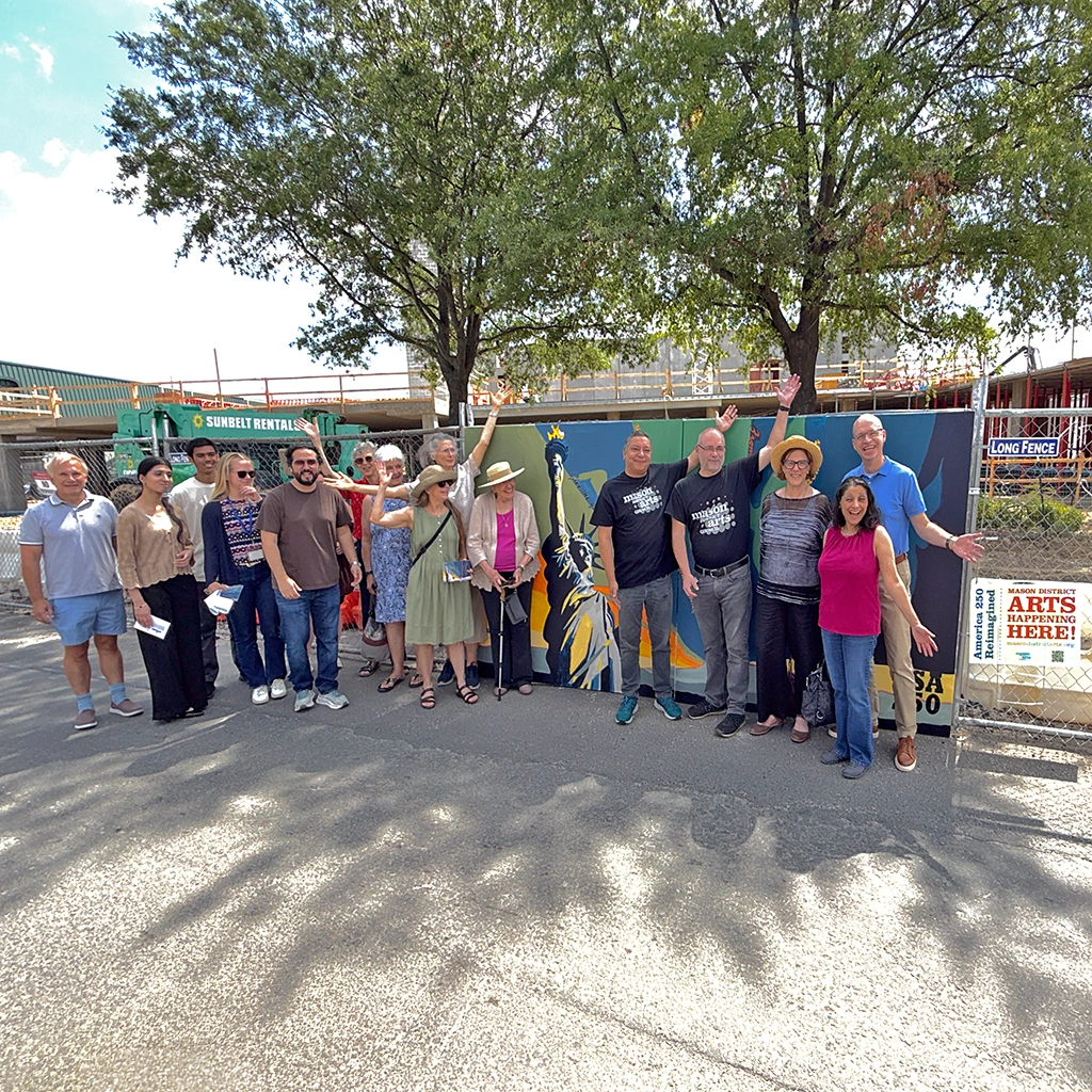 Members of the Mason District Arts Council with Mason District Supervisor Andres Jimenez and his staff, former Mason District Supervisor Penny Gross, and Stuart Holt from Arts Fairfax pose with the completed community mural on July 24, 2026.