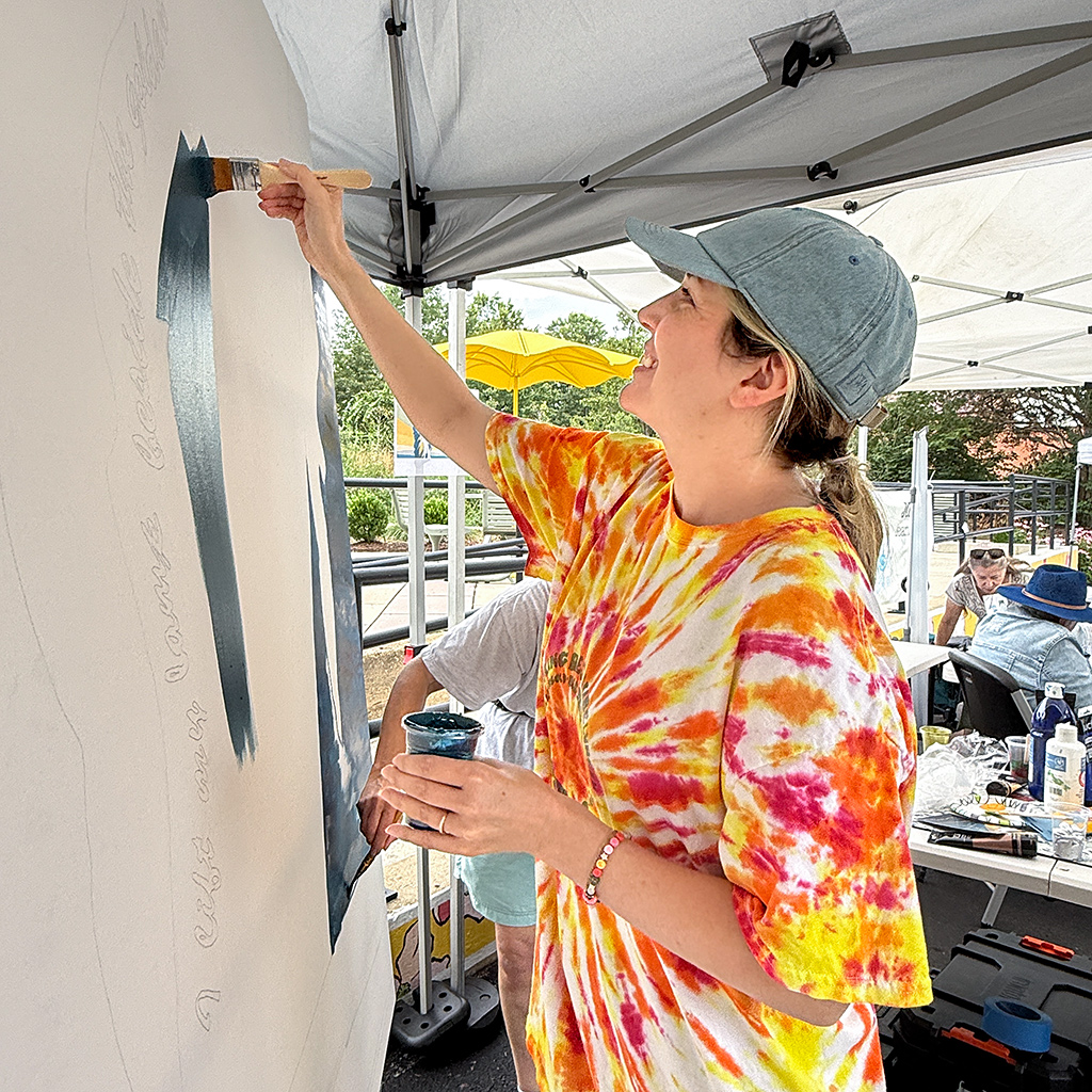 Community member working on the mural project led by Artlords.
