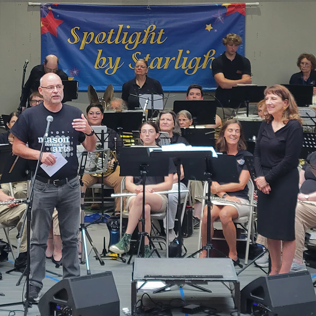 James Albright, chair of the Mason District Arts Council, introduces the City of Falls Church Concert Band on July 24 at the Mason District Park Amphitheater to kick-off the summer Spotlight by Starlight concert series.